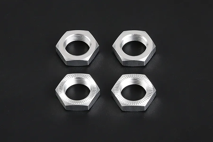 Four silver aluminium RC wheel nuts arranged in a square on a dark background, showing both smooth and serrated sides.