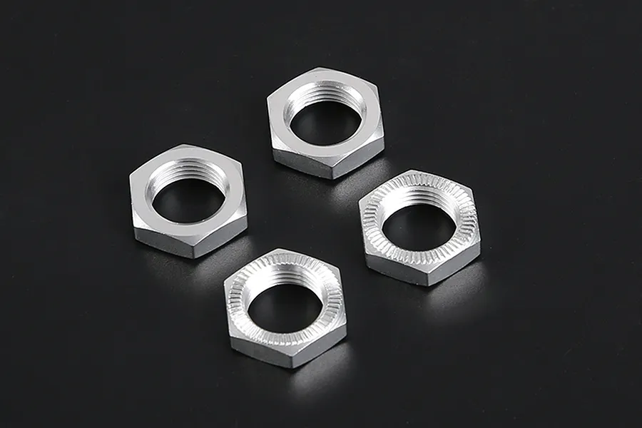 Four silver aluminium hex wheel nuts for RC cars arranged on a black background.