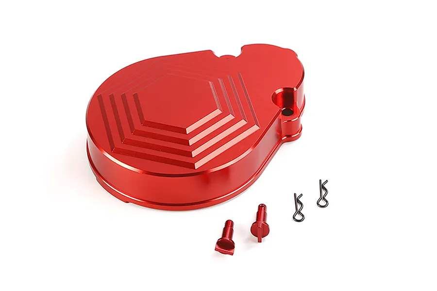 A red anodized aluminium transmission case for an RC car, featuring a hexagonal pattern, accompanied by two small red metal pins and two wire R-clips.