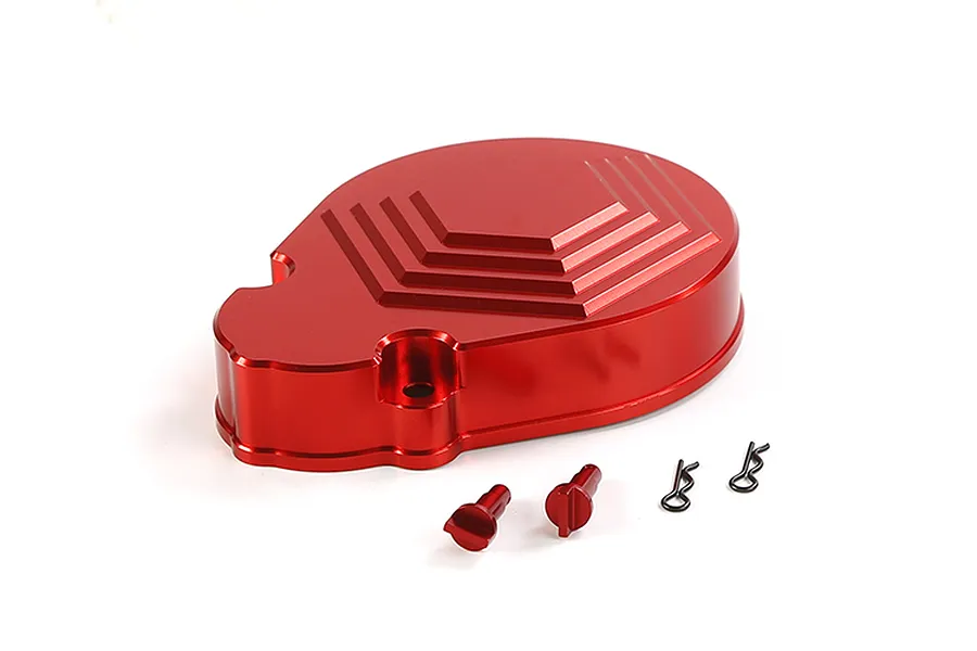 A red anodized aluminium transmission case cover for an RC car, shown with two small red pins and two black R-clips on a white background.