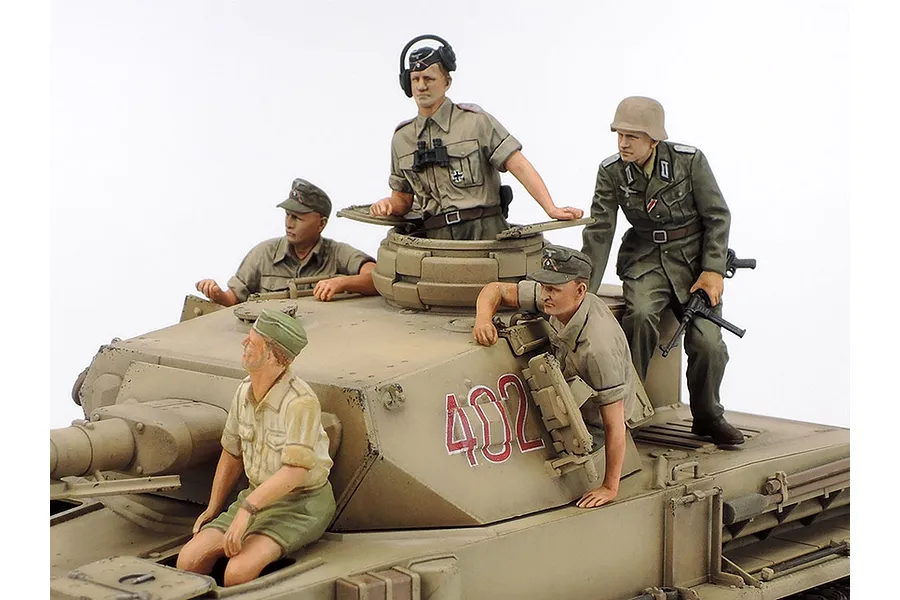 A detailed 1/35 scale model of a German Panzer IV tank with four painted crew figures positioned on the turret and hull.