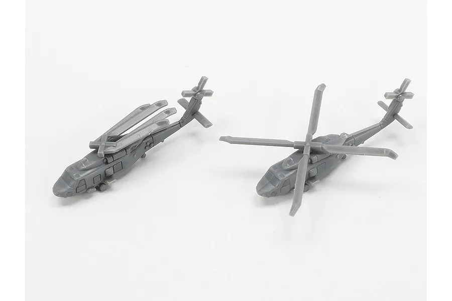 Two unpainted grey plastic 1/700 scale helicopter models for a ship kit, one with folded rotors and one with extended rotors.