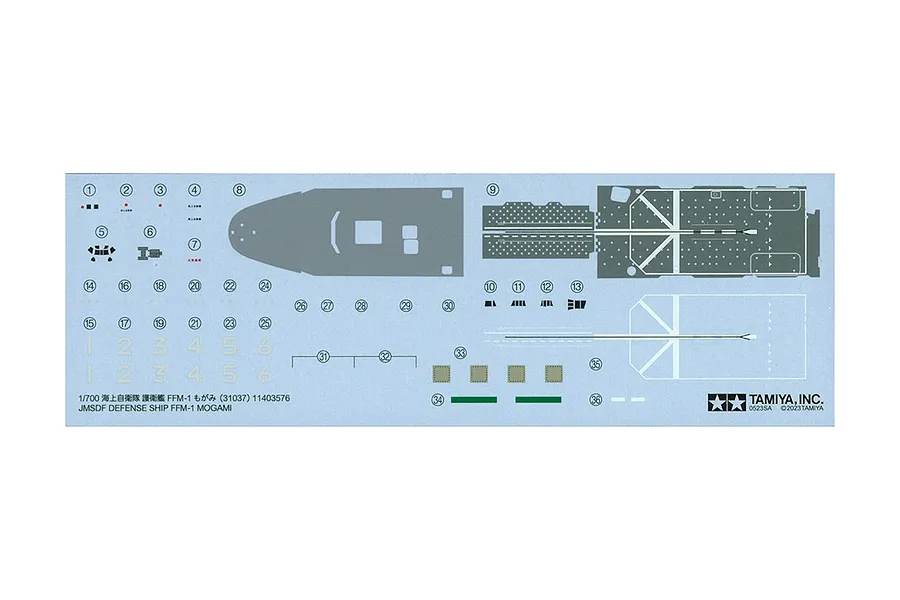 A decal sheet for the Tamiya 1/700 scale JMSDF FFM-1 Mogami model kit, featuring various markings, numbers, and deck patterns on a light blue backing.