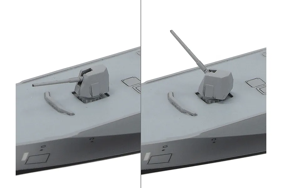 Close-up comparison of a 1/700 scale model ship gun turret in two different elevation positions on a grey deck.