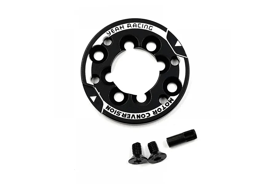 A black aluminium motor mount conversion plate by Yeah Racing, accompanied by two flat-head screws and a small metal spacer on a white background.