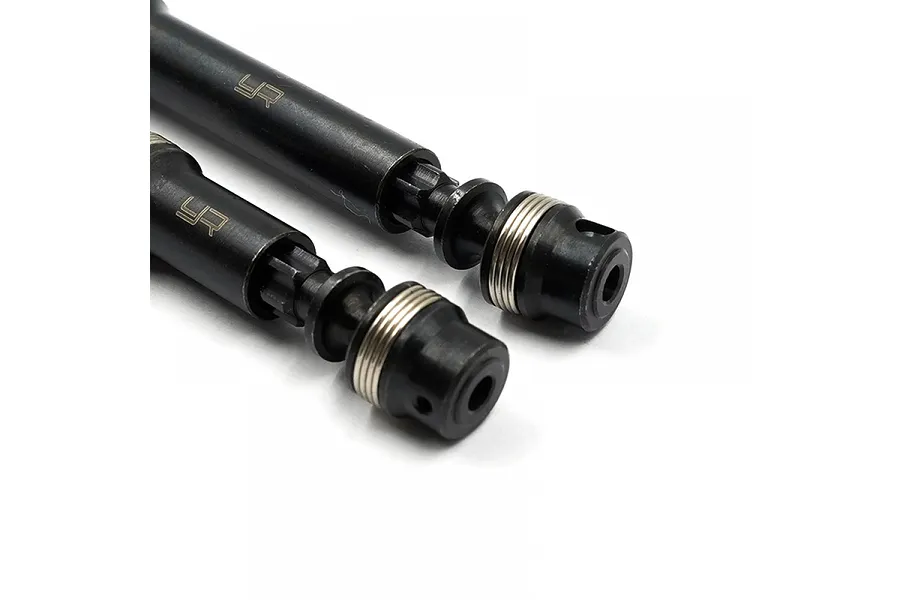 Close-up of two black Yeah Racing HD steel centre driveshafts with silver spring collars on a white background.