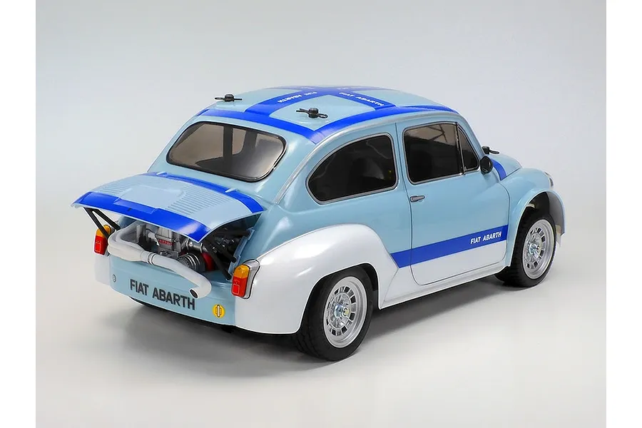Rear three-quarter view of a Tamiya Fiat Abarth 1000TCR RC car with blue and white livery and an open rear engine bay.