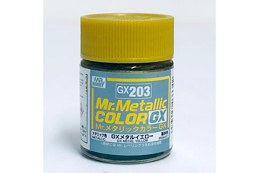A small glass jar of Mr. Hobby GX Metallic Yellow paint with a yellow screw-top lid, set against a plain white background.