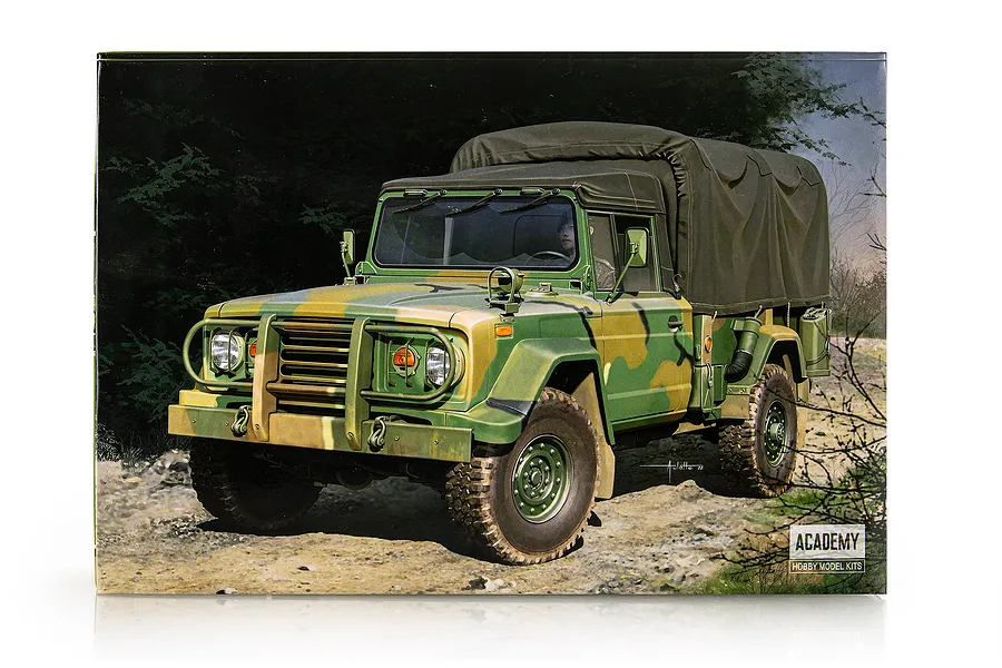 Box art for Academy 1/35 scale K311A1 R.O.K Army military truck model kit showing a camouflaged vehicle on a dirt path.