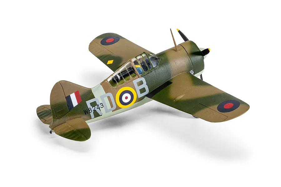 A completed 1/72 scale plastic model of a Brewster Buffalo fighter plane, painted in a green and brown camouflage scheme with RAF markings.