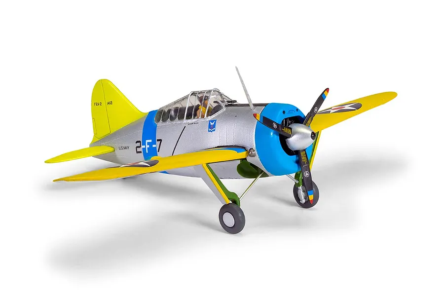 A fully assembled and painted 1/72 scale plastic model of a Brewster Buffalo fighter plane in US Navy livery, featuring silver, yellow, and blue paint.