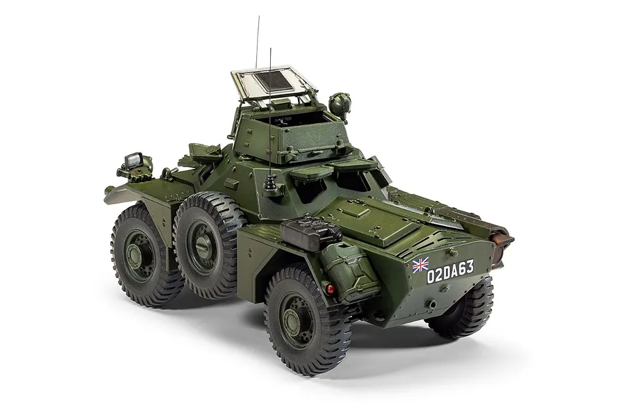 A fully assembled and painted 1/35 scale model of a Ferret Scout Car MK.2 in olive green, featuring a turret, spare wheel, and British military markings.