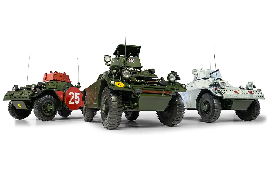 Three assembled and painted 1/35 scale Ferret Scout Car model kits in different liveries, displayed against a white background.