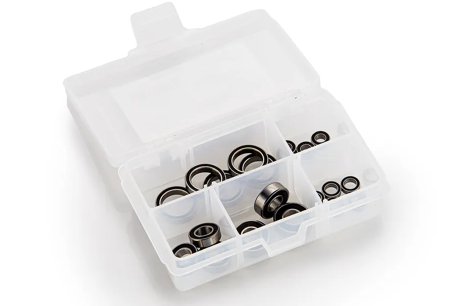 A clear plastic storage box containing various sizes of metal ball bearings with black rubber seals.