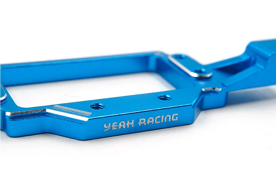 A close-up of a blue anodized aluminium RC servo mount by Yeah Racing, showing the engraved logo and mounting holes.