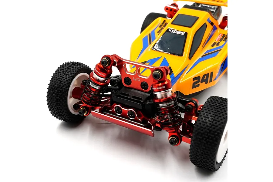Close-up of a yellow Kyosho RC buggy featuring red Yeah Racing aluminium shock absorbers installed on the front suspension.