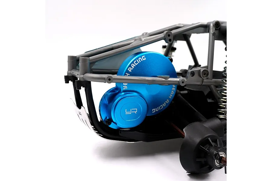 A blue anodized aluminium gear cover with Yeah Racing branding installed on an RC car chassis.