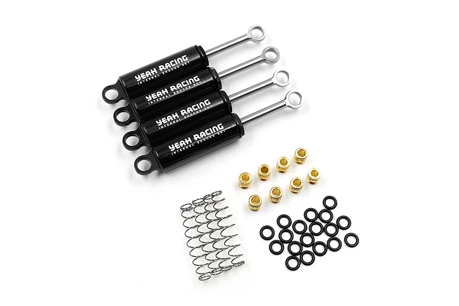 Four black Yeah Racing internal shock absorbers with silver shafts, accompanied by brass bushings, O-rings, and springs on a white background.