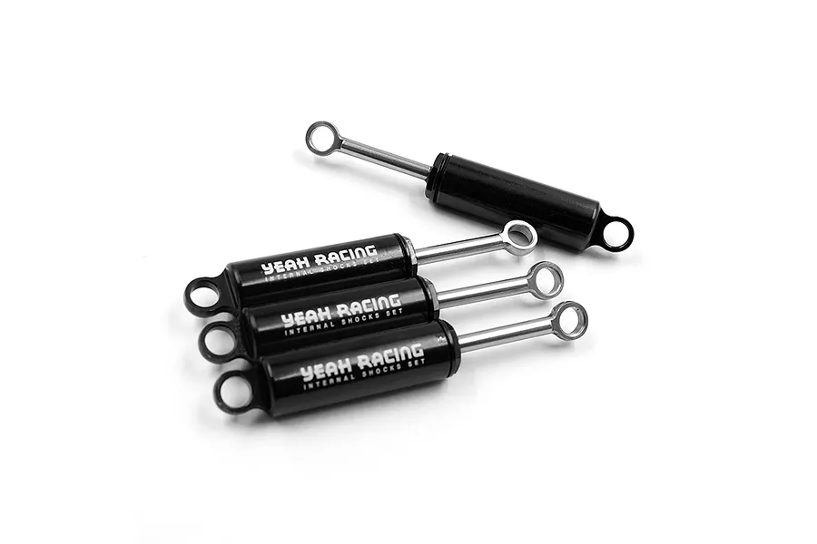 Four black aluminium RC shock absorbers from Yeah Racing arranged on a white background.