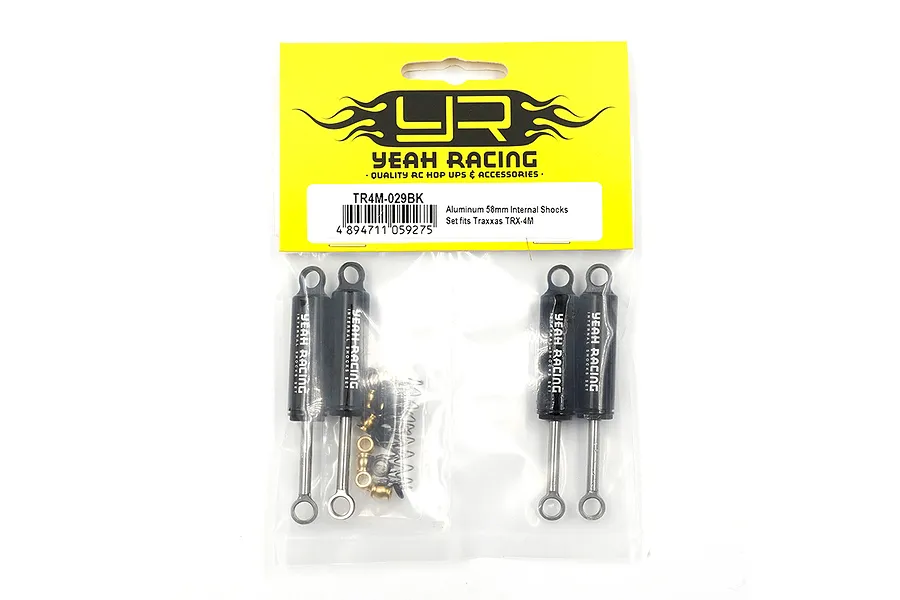 Four black Yeah Racing aluminium shock absorbers in a sealed plastic retail bag with a yellow header card.
