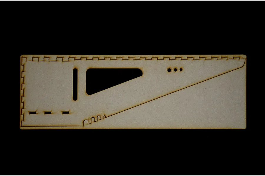 A single flat laser-cut MDF wooden panel component for the Italeri modelling workstation, featuring various slots and cutouts.