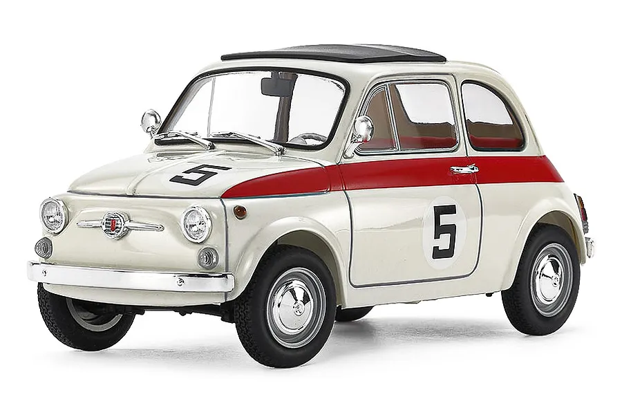 A studio shot of a Tamiya 1/24 scale Fiat 500F model car, painted cream and red with the number 5 on the hood and doors.