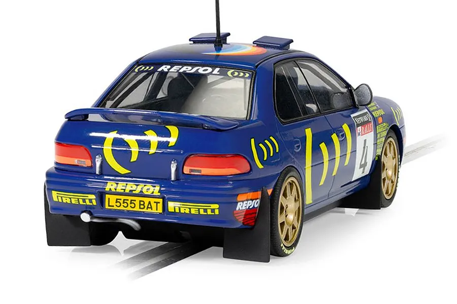 Rear three-quarter view of a blue Scalextric 1/32 scale 1995 Subaru Impreza WRX slot car with gold wheels and rally livery.