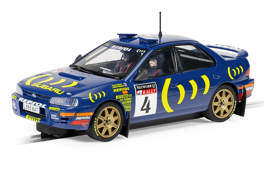 A 1/32 scale Scalextric slot car model of the blue 1995 Subaru Impreza WRX rally car driven by Colin McRae, featuring gold wheels and racing decals.