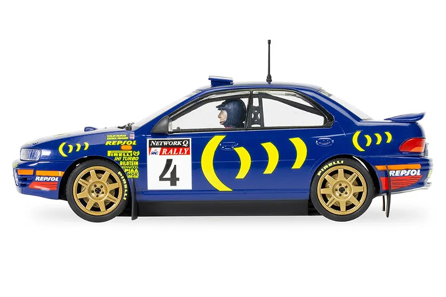 Side view of a 1/32 scale blue Scalextric Subaru Impreza WRX slot car with number 4 and Repsol rally livery.
