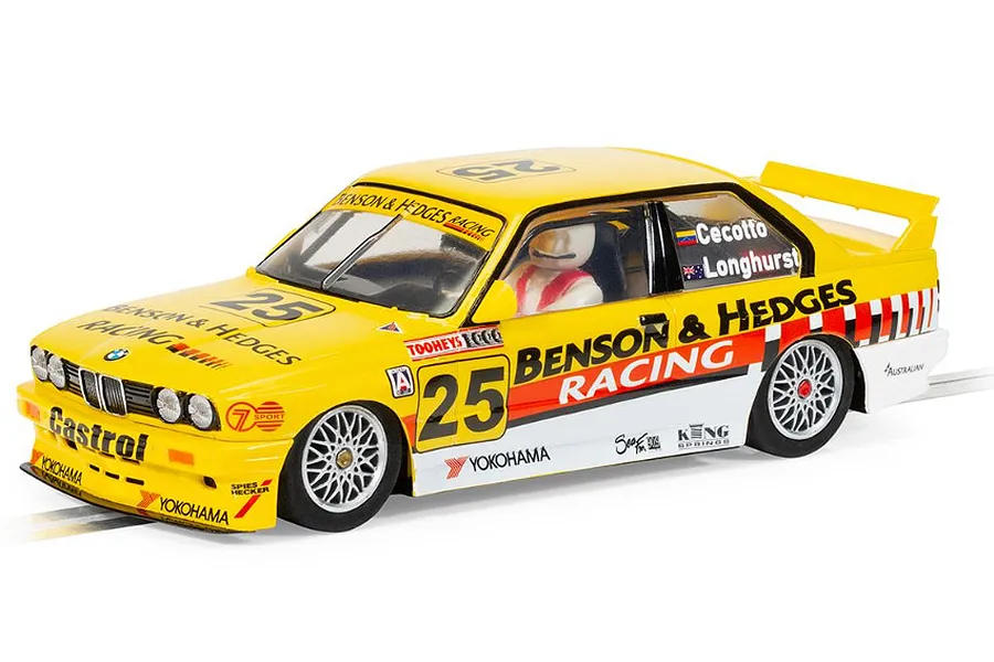 A 1/32 scale Scalextric slot car model of a yellow BMW E30 M3 race car, featuring Benson &amp; Hedges Racing livery and number 25, on a white background.