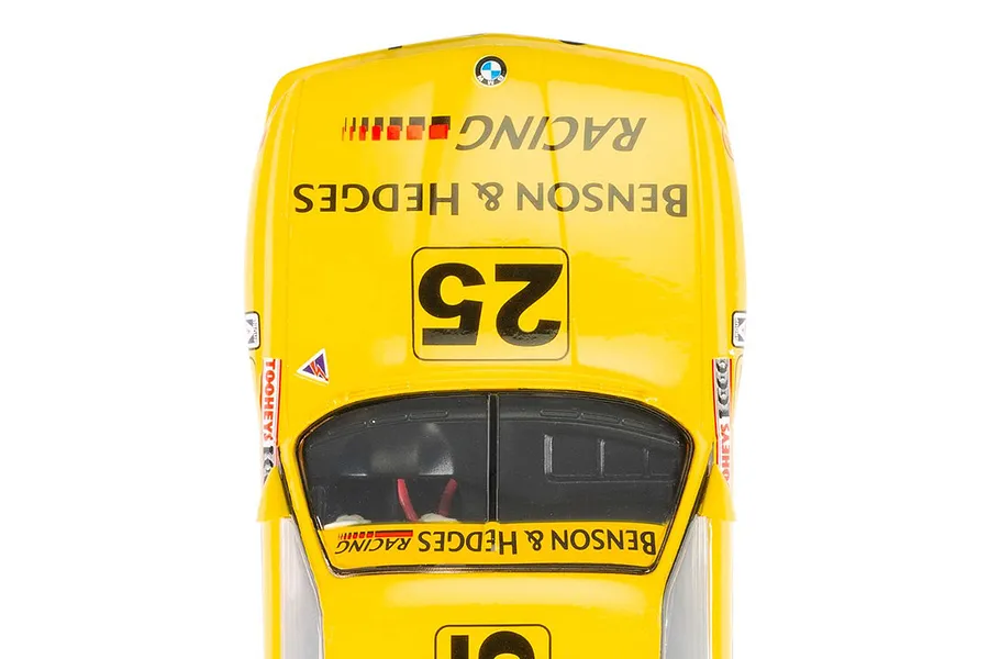 Top-down view of a yellow Scalextric 1/32 scale BMW E30 M3 slot car featuring Benson &amp; Hedges racing livery and number 25.