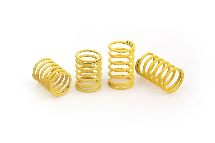 Four yellow XRAY RC shock springs arranged on a white background.