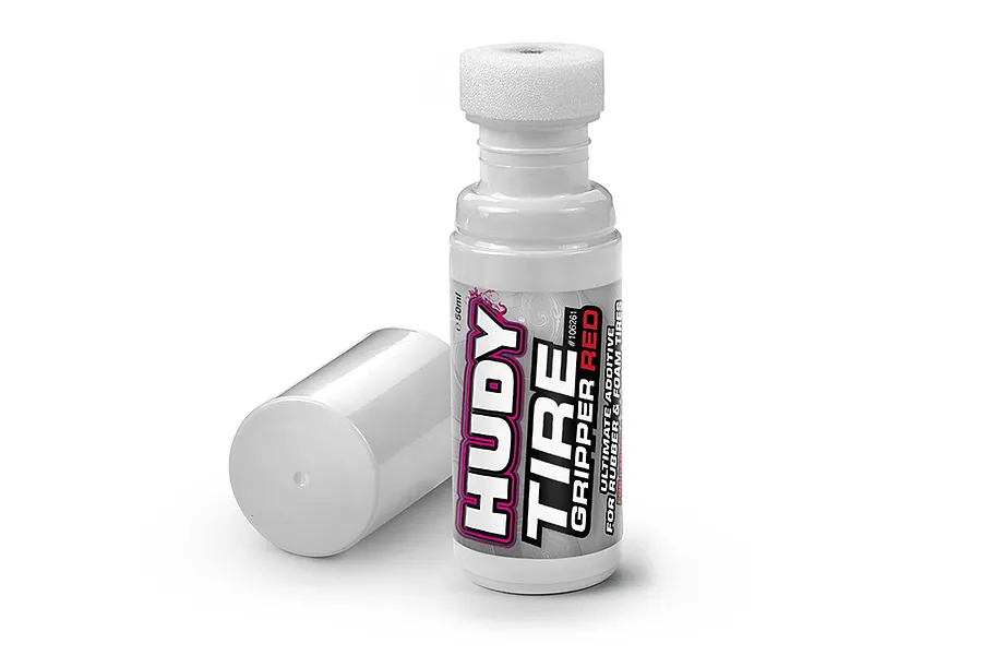 A bottle of Hudy Tyre Gripper Red 50ml tire additive with its white cap removed and placed beside it on a white background.