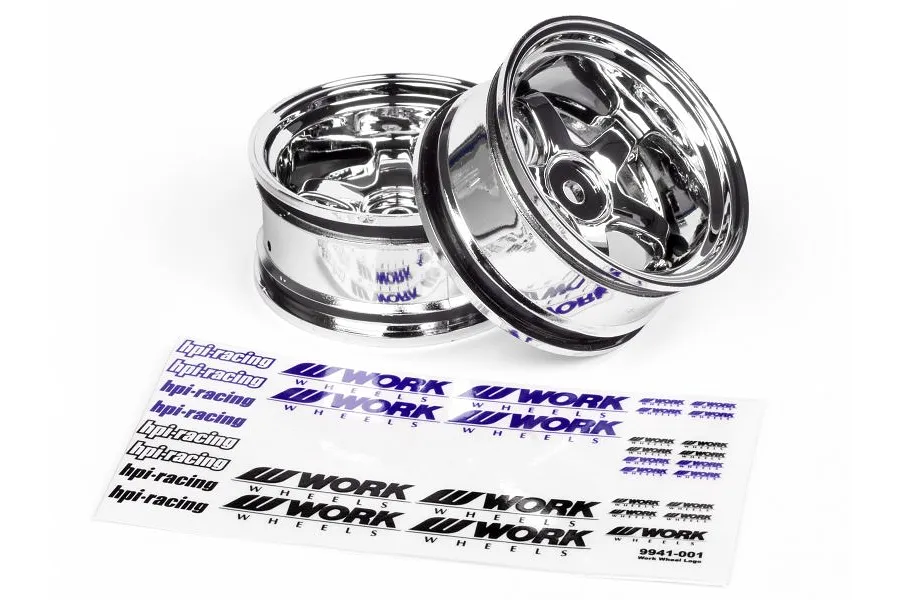 Two chrome HPI Work Meister S1 RC car rims with a decal sheet featuring HPI and Work Wheels logos on a white background.