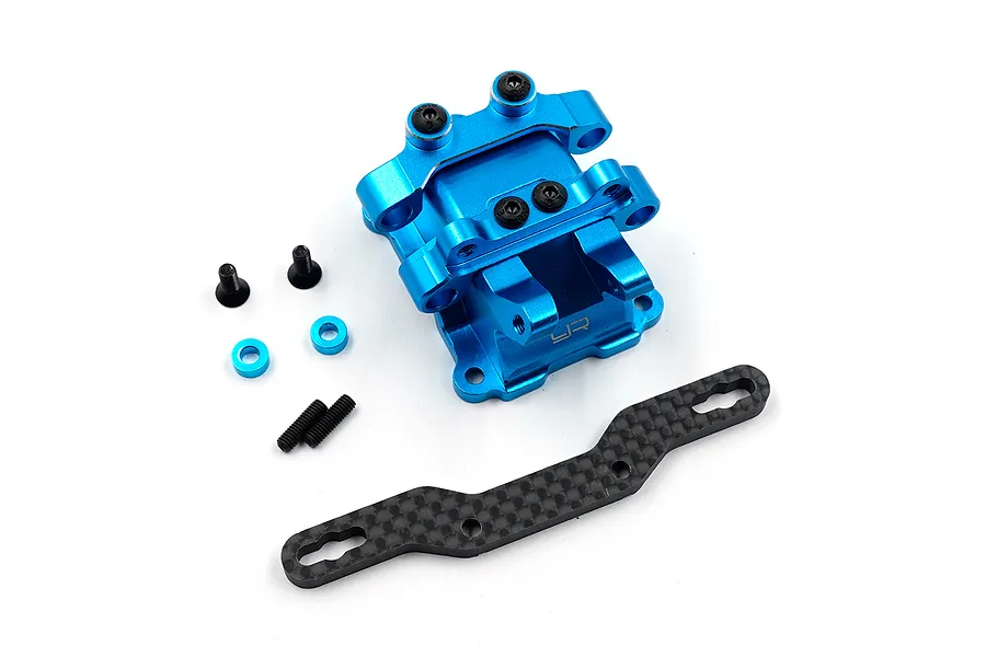 Yeah Racing blue aluminium gearbox cover with a carbon fibre shock absorber mount and included hardware on a white background.