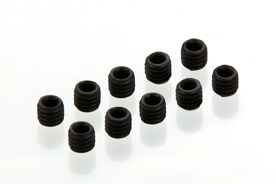 A set of ten small black metal grub screws arranged in a loose grid on a white background.