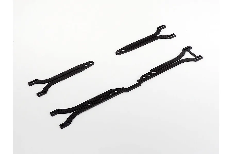 Three carbon fiber suspension or chassis components for a Tamiya RC touring car kit on a white background.