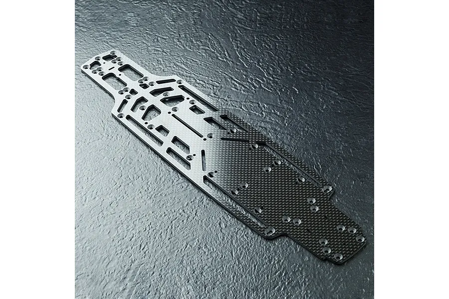 A top-down view of an MST lightweight carbon fibre RC car chassis plate featuring a complex cutout design and numerous mounting holes.
