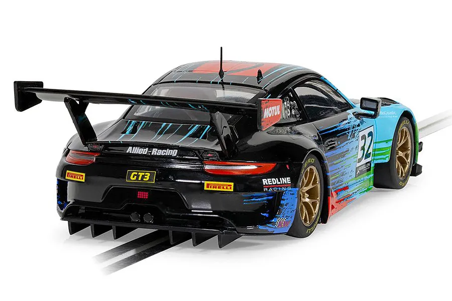 Rear three-quarter view of a Scalextric 1/32 scale Porsche 911 GT3 R Redline Racing slot car on a track.