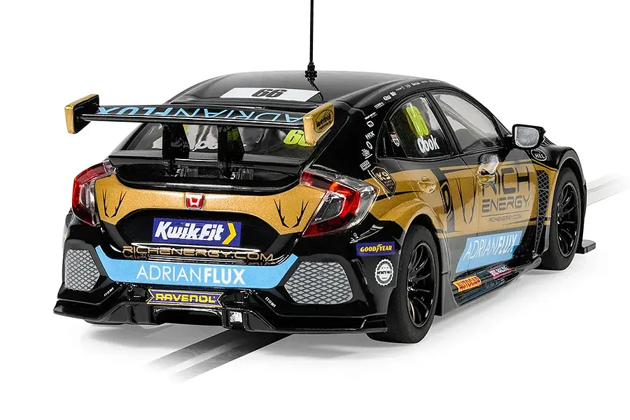 Rear three-quarter view of a Scalextric 1/32 scale Honda Civic FK8 Type R BTCC slot car in black and gold livery with Rich Energy branding.