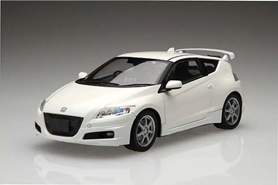 A studio shot of a white 1/24 scale Honda CR-Z plastic model car with Mugen custom parts, shown from a front three-quarter angle.