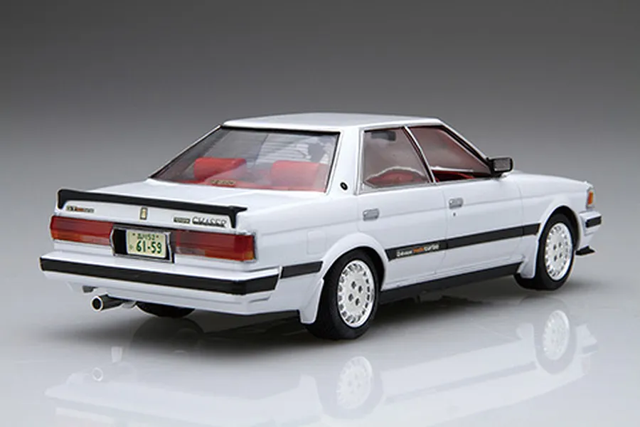 A 1/24 scale plastic model kit of a white Toyota Chaser GX71, viewed from the rear three-quarter angle against a grey studio background.