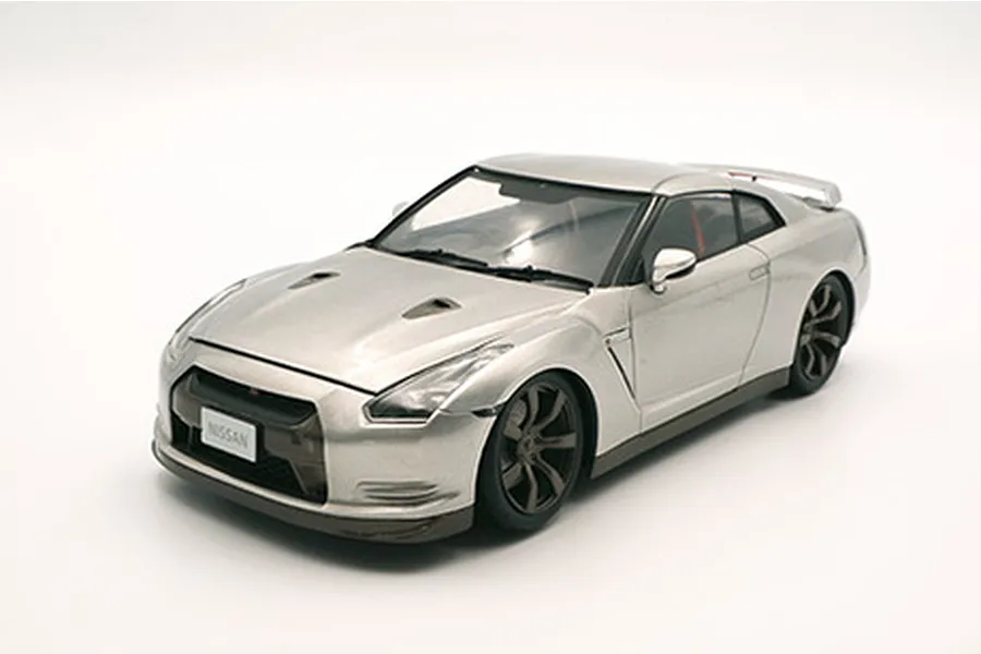 A silver 1/24 scale model of a Nissan R35 GT-R, showing the front three-quarter view against a plain white background.
