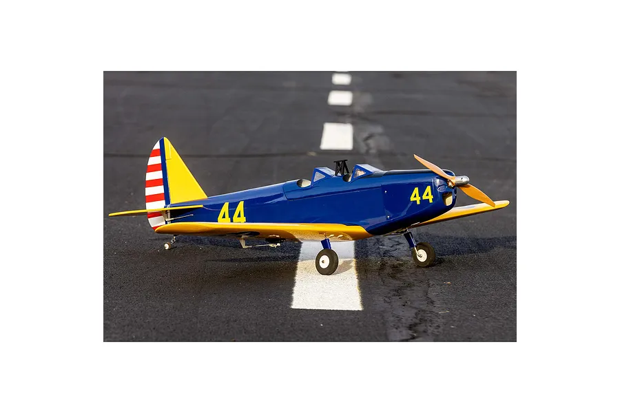A blue and yellow Hangar 9 PT-19 RC plane sitting on an asphalt runway with white markings.