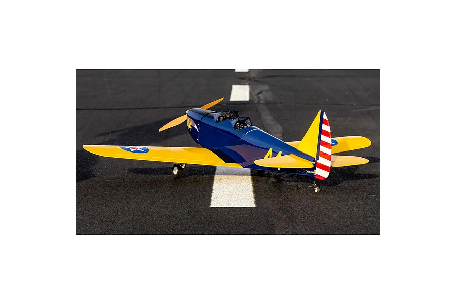 Hangar 9 PT-19 RC warbird model plane sitting on an asphalt runway, featuring a blue and yellow paint scheme with US military-style markings.