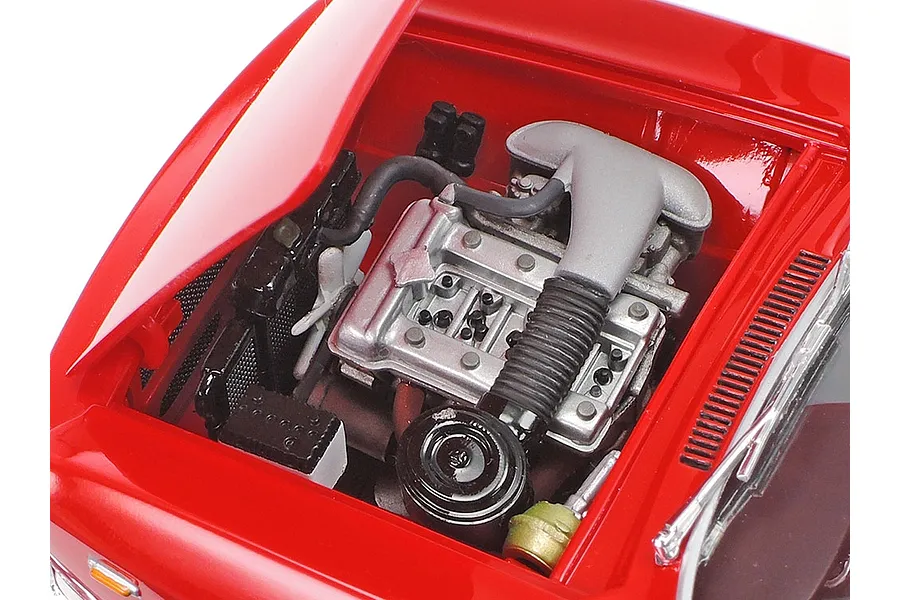 Close-up of the detailed engine bay of a 1/24 scale Tamiya Alfa Romeo Giulia GTA model car, showing the engine, radiator, and battery.