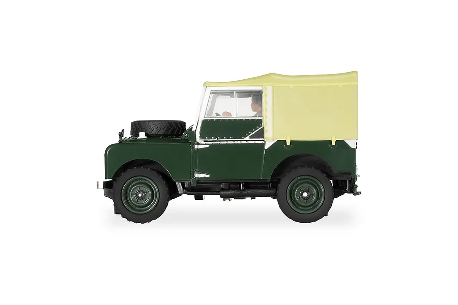 Side profile of a green Scalextric 1/32 scale Land Rover Series 1 slot car with a tan soft top.