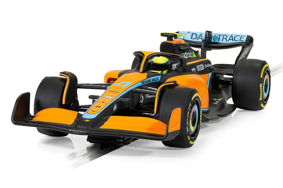 A 1/32 scale Scalextric McLaren MCL36 slot car in orange, black, and light blue livery, featuring the number 4 and sponsor logos.
