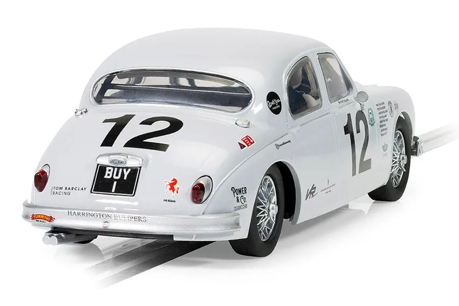 Rear three-quarter view of a white Scalextric 1/32 scale Jaguar MK1 slot car, number 12, with BUY 1 license plate, on a track.