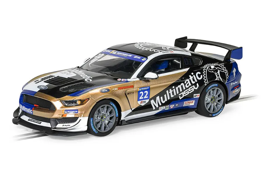 Scalextric 1/32 scale Ford Mustang GT4 slot car in Multimatic Motorsport livery with gold, black, and white paint scheme.